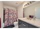 Bathroom featuring a floral shower curtain and updated vanity with marble countertop at 4023 Stillwater Dr, Duluth, GA 30096