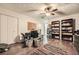 Bedroom featuring a ceiling fan, built-in bookshelves, a desk, and wood-look floors at 4023 Stillwater Dr, Duluth, GA 30096