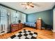 Bedroom with hardwood floors, large window, and curtains at 4023 Stillwater Dr, Duluth, GA 30096