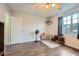 Well-lit bedroom with ceiling fan, window, and gray wood-look flooring at 4023 Stillwater Dr, Duluth, GA 30096