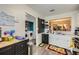 Bright kitchen features modern appliances, white cabinets and view into the laundry room at 4023 Stillwater Dr, Duluth, GA 30096