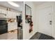 Entry to kitchen with white cabinets, black appliances, and exterior door at 4023 Stillwater Dr, Duluth, GA 30096