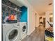 Laundry room with blue accent wall and modern washer and dryer at 4023 Stillwater Dr, Duluth, GA 30096