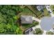 Birds eye view of a well maintained grey roof with circle driveway surrounded by mature trees at 4814 Little Cove Ct, Auburn, GA 30011