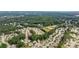Aerial view of a suburban neighborhood with many homes surrounded by lush green trees at 4814 Little Cove Ct, Auburn, GA 30011