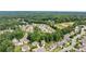 Aerial view of a suburban neighborhood with many homes surrounded by lush green trees at 4814 Little Cove Ct, Auburn, GA 30011