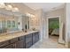 Large bathroom with double vanity, granite countertops, and a glass-enclosed shower at 4814 Little Cove Ct, Auburn, GA 30011
