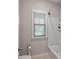 Cozy bathroom area featuring a shower and bathtub with a window, complete with modern fixtures at 4814 Little Cove Ct, Auburn, GA 30011