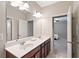 Bright bathroom with double sinks, granite countertop, and an adjacent bedroom view at 4814 Little Cove Ct, Auburn, GA 30011