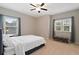 Cozy bedroom features neutral tones, windows, and a stylish bench, creating a relaxing retreat at 4814 Little Cove Ct, Auburn, GA 30011