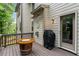 View of the deck with a wine barrel fire pit, a grill, and access to the house at 4814 Little Cove Ct, Auburn, GA 30011