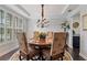 Elegant dining room with a beautiful chandelier, tray ceiling, and seating for six at 4814 Little Cove Ct, Auburn, GA 30011