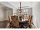 Elegant dining room featuring wainscoting, and a decorative chandelier with seating for six at 4814 Little Cove Ct, Auburn, GA 30011