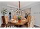 Formal dining room with a chandelier, hardwood floors, and an elegant dining table at 4814 Little Cove Ct, Auburn, GA 30011