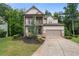 Charming two-story home with a landscaped front yard and two-car garage at 4814 Little Cove Ct, Auburn, GA 30011