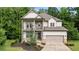 Charming two-story home features a welcoming front porch and a well-manicured lawn at 4814 Little Cove Ct, Auburn, GA 30011