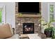 Living room fireplace with stone surround and large television at 4814 Little Cove Ct, Auburn, GA 30011