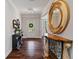 Bright foyer features hardwood floors, console table, and decorative mirror at 4814 Little Cove Ct, Auburn, GA 30011
