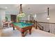 Open game room with billiard table, pendant lighting and bar seating at 4814 Little Cove Ct, Auburn, GA 30011