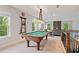 Spacious game room with a pool table and beautiful overhead lighting fixture at 4814 Little Cove Ct, Auburn, GA 30011