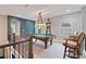 Game room with pool table, custom light fixture, and seating, perfect for entertaining at 4814 Little Cove Ct, Auburn, GA 30011