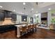 Open-concept kitchen with a large island, dark cabinetry, and views of the living area at 4814 Little Cove Ct, Auburn, GA 30011