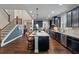 Large kitchen with seating, granite countertop island, and stainless steel appliances at 4814 Little Cove Ct, Auburn, GA 30011