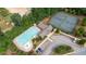 Aerial view of the neighborhood pool and tennis courts, surrounded by lush trees at 4814 Little Cove Ct, Auburn, GA 30011
