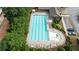 Aerial view of the neighborhood pool and sundeck, lined with lounge chairs and umbrellas at 4814 Little Cove Ct, Auburn, GA 30011