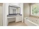 Bright bathroom with soaking tub, vanity, and tiled walls at 1093 Athena Ct, Acworth, GA 30101