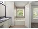 Bright bathroom with soaking tub, vanity, and a window at 1093 Athena Ct, Acworth, GA 30101