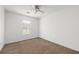Cozy bedroom with neutral carpet, ceiling fan, and a sunny window at 1093 Athena Ct, Acworth, GA 30101