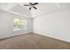 Spacious bedroom with carpet flooring, ceiling fan, and a large window at 1093 Athena Ct, Acworth, GA 30101