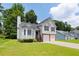 View of the home's front exterior with a well-maintained lawn and two-car garage at 1093 Athena Ct, Acworth, GA 30101