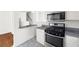 Modern kitchen with stainless steel appliances, gray countertops, and white cabinetry at 1093 Athena Ct, Acworth, GA 30101
