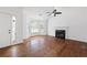Bright living room featuring a fireplace, hardwood floors, and large windows at 1093 Athena Ct, Acworth, GA 30101