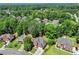 Aerial view of homes in a lush community surrounded by dense trees at 5054 Kingsbridge Pass, Powder Springs, GA 30127