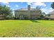 Large backyard with a grill, a well-manicured lawn, and a home in the background at 5054 Kingsbridge Pass, Powder Springs, GA 30127
