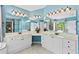 Bright bathroom featuring double vanity, with blue walls and tile flooring at 5054 Kingsbridge Pass, Powder Springs, GA 30127
