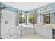 Bright bathroom featuring double vanity, glass enclosed shower, corner tub, and tiled floor at 5054 Kingsbridge Pass, Powder Springs, GA 30127