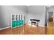 Neutral bedroom featuring hardwood floors, white storage unit, and space for a study area at 5054 Kingsbridge Pass, Powder Springs, GA 30127