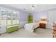Cozy bedroom featuring natural light, light purple walls, and carpet flooring at 5054 Kingsbridge Pass, Powder Springs, GA 30127