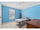 Comfortable bedroom with blue walls, carpet, and window with natural light at 5054 Kingsbridge Pass, Powder Springs, GA 30127