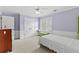 Bedroom with light purple walls, carpet flooring and white trim at 5054 Kingsbridge Pass, Powder Springs, GA 30127