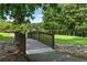 Wooden bridge spanning a rocky creek in a serene park-like setting at 5054 Kingsbridge Pass, Powder Springs, GA 30127