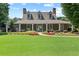 Charming clubhouse boasts a manicured lawn, beautiful landscaping, and a welcoming entrance at 5054 Kingsbridge Pass, Powder Springs, GA 30127
