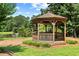 Charming gazebo nestled in a tranquil park setting by a pond at 5054 Kingsbridge Pass, Powder Springs, GA 30127