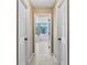 Hallway view of a spacious bathroom with white cabinets and tile floors at 5054 Kingsbridge Pass, Powder Springs, GA 30127