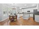 Bright kitchen with white cabinets, granite countertops, and a stainless-steel refrigerator at 5054 Kingsbridge Pass, Powder Springs, GA 30127