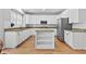 Updated kitchen with white cabinetry, granite countertops, and stainless-steel appliances at 5054 Kingsbridge Pass, Powder Springs, GA 30127